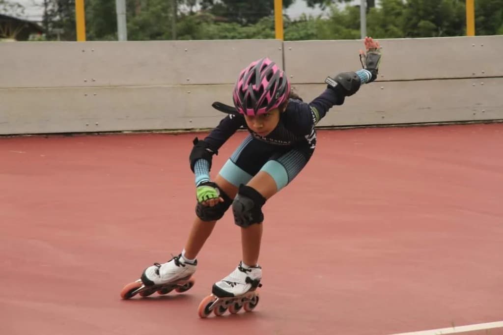 Young skater executing crossover turn on the rink